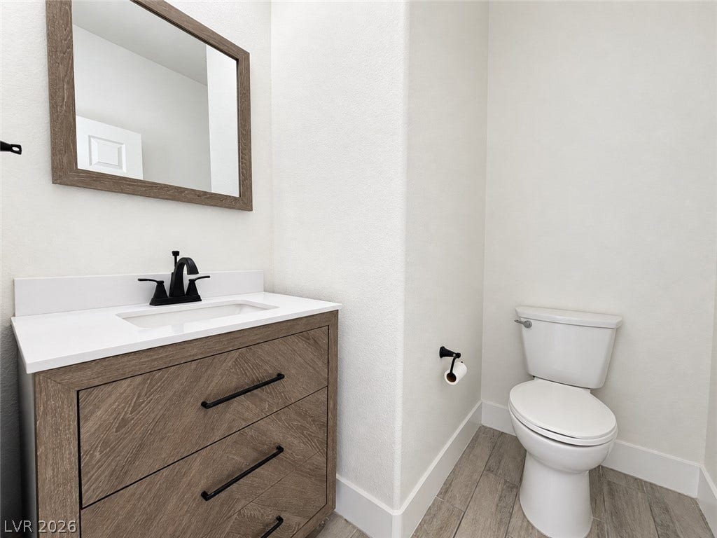 2321 Breckle Key Avenue, North Las Vegas, NV 89081 A modern vanity with a white countertop anchors this clean powder room.