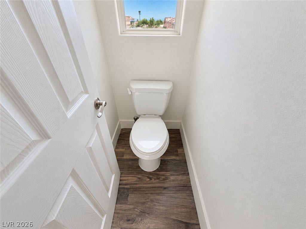 2321 Breckle Key Avenue, North Las Vegas, NV 89081 A high window brings natural light into this compact powder room with wood-look flooring.
