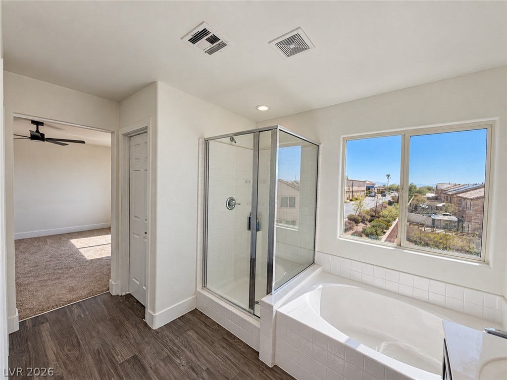 2321 Breckle Key Avenue, North Las Vegas, NV 89081 Sunlight streams through the large window over the soaking tub and separate shower enclosure.
