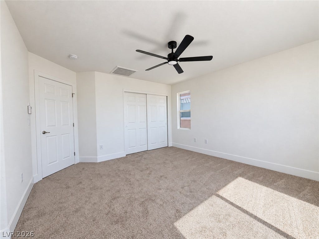 2321 Breckle Key Avenue, North Las Vegas, NV 89081 Plush carpeting and crisp white walls define this comfortable bedroom space.