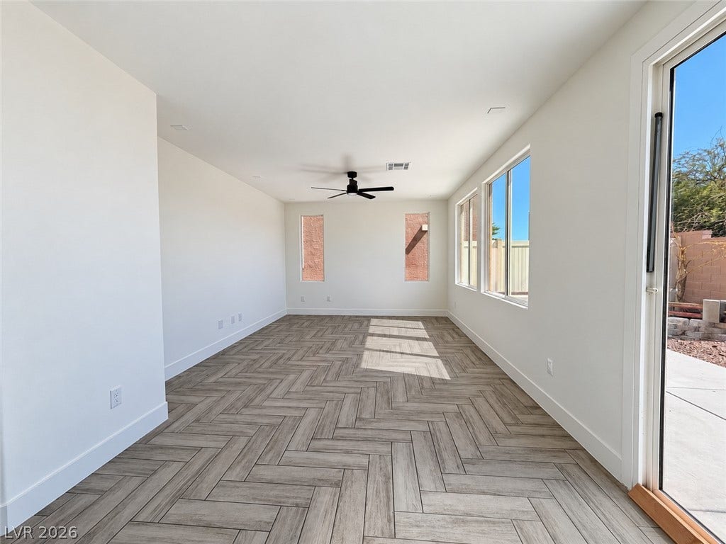 2321 Breckle Key Avenue, North Las Vegas, NV 89081 Herringbone pattern floors and abundant natural light define this versatile, airy living space.