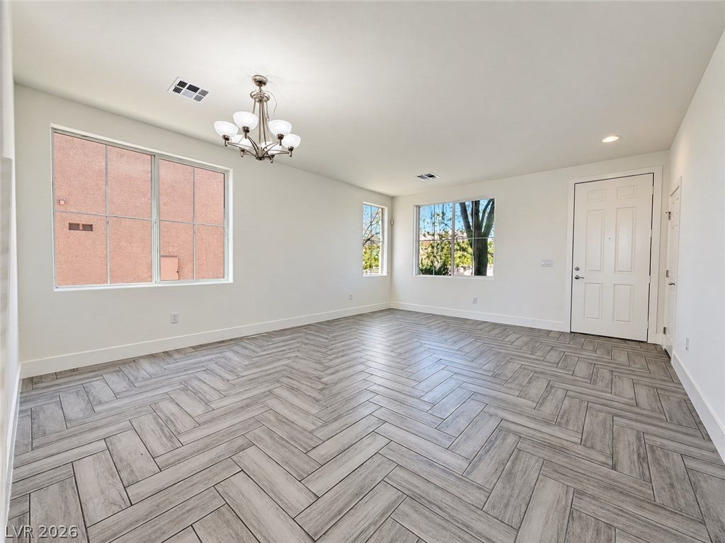 2321 Breckle Key Avenue, North Las Vegas, NV 89081 Chevron patterned tile flooring accents this open living space illuminated by multiple windows.
