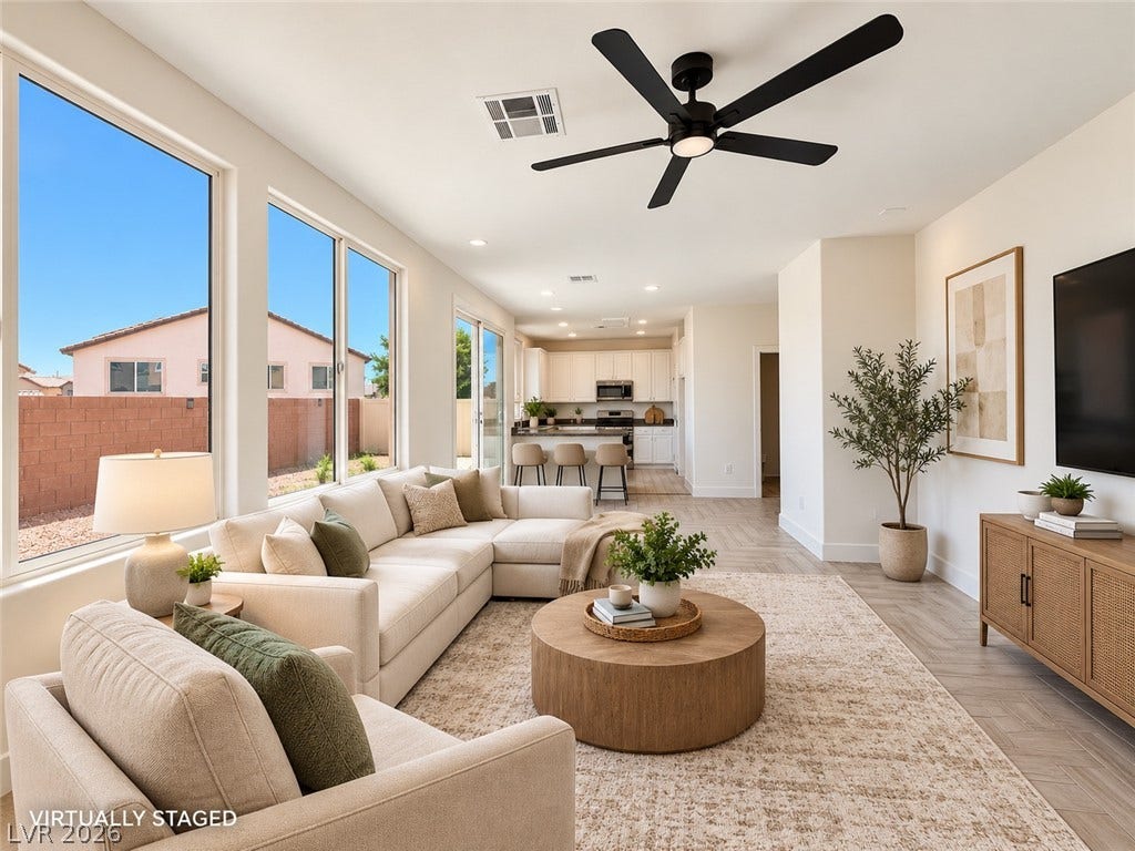 2321 Breckle Key Avenue, North Las Vegas, NV 89081 Sunlight streams through large windows into this spacious living area with tile flooring.