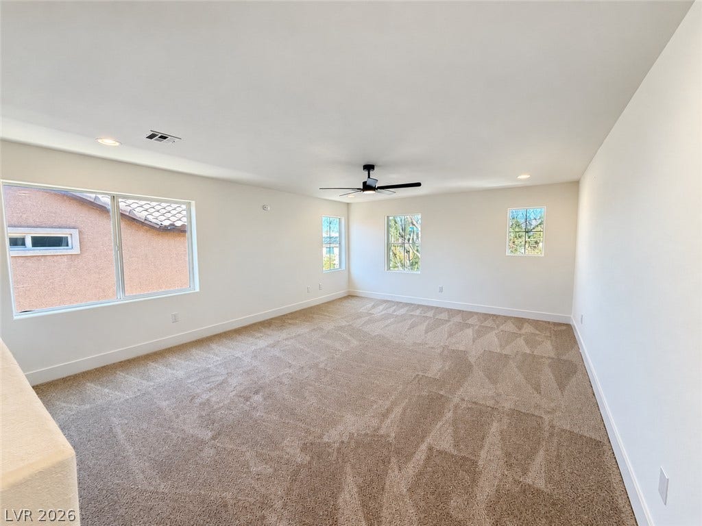 2321 Breckle Key Avenue, North Las Vegas, NV 89081 Generous windows fill this carpeted upstairs living space with natural light.