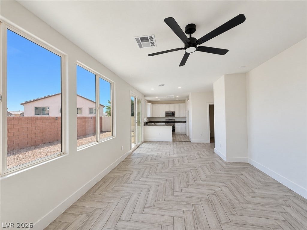 2321 Breckle Key Avenue, North Las Vegas, NV 89081 An open layout flows effortlessly across herringbone pattern tile floors toward the kitchen.
