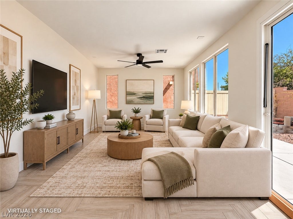 2321 Breckle Key Avenue, North Las Vegas, NV 89081 Sunlight streams through expansive windows, highlighting the clean lines and elegant wood-style flooring.