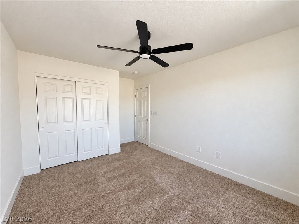 2321 Breckle Key Avenue, North Las Vegas, NV 89081 Plush carpeting anchors this clean bedroom space featuring structured sliding closet doors.