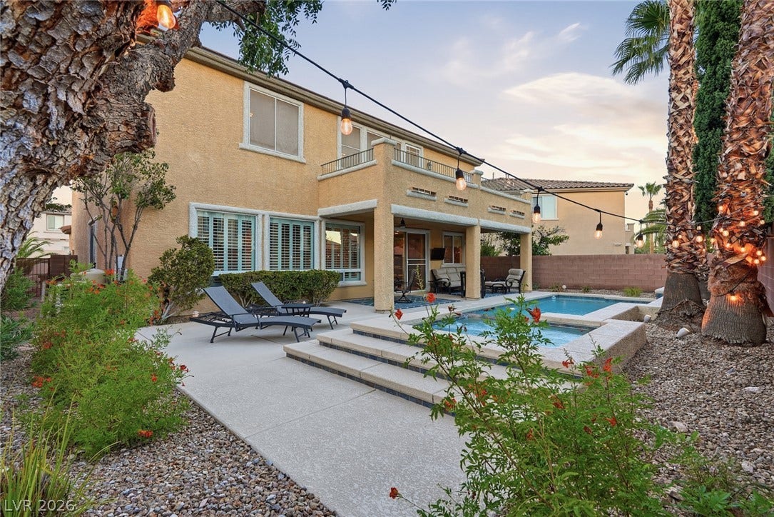 A sparkling in-ground pool and integrated spa anchor this private desert-landscaped backyard sanctuary.