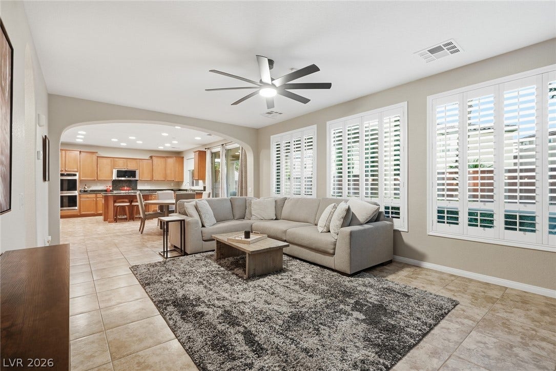 An open floorplan seamlessly connects the airy living area to a spacious kitchen.