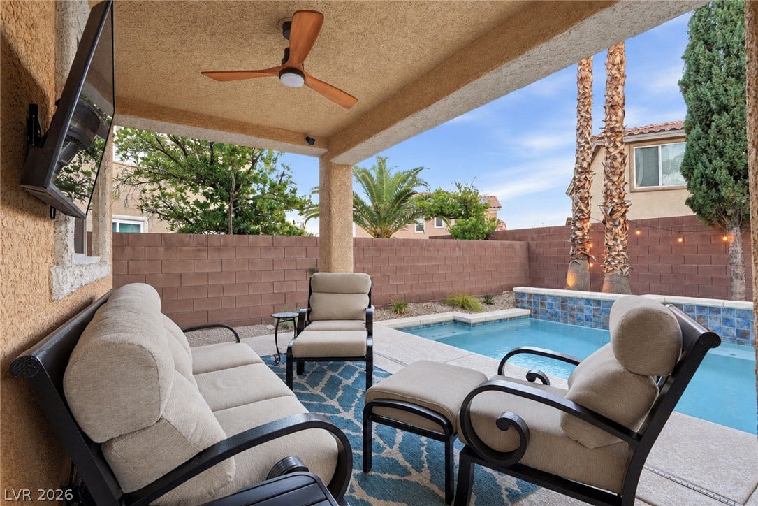 A sheltered concrete patio overlooks the private backyard swimming pool.