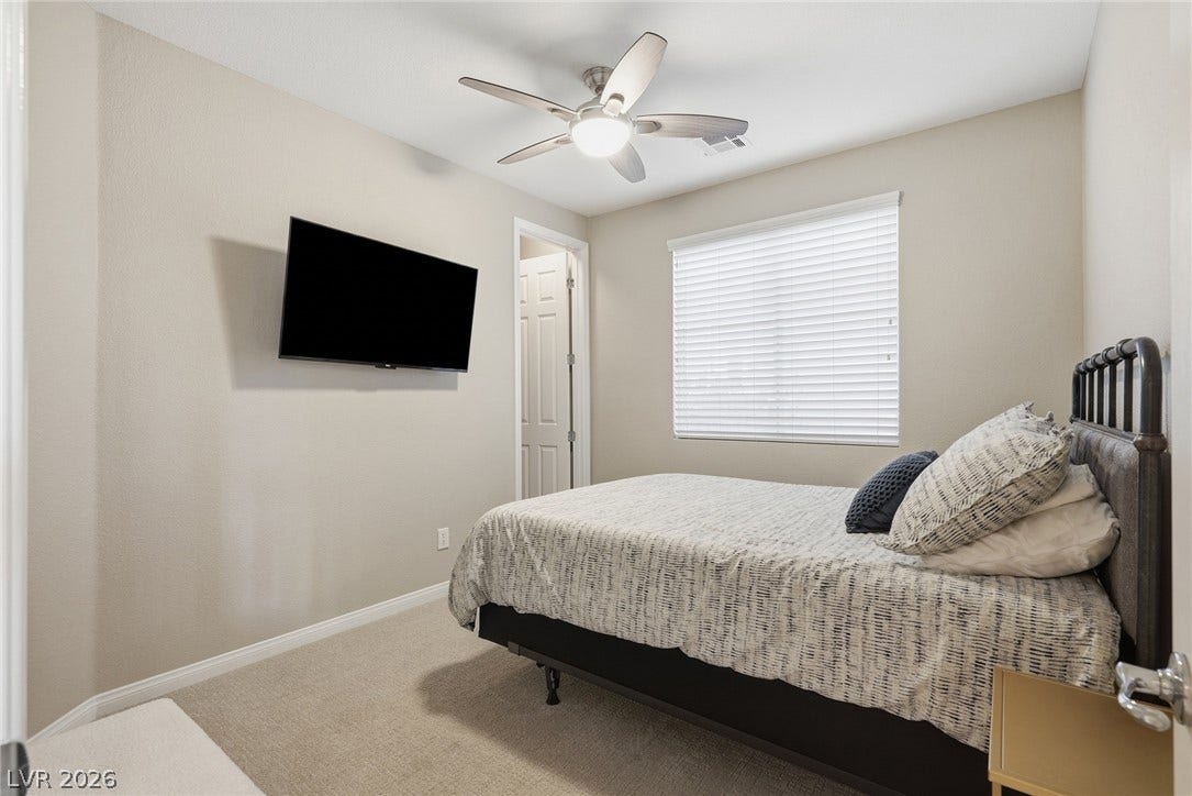 Bedroom 2- Soft carpeting pairs with a large window in this peaceful secondary bedroom.
