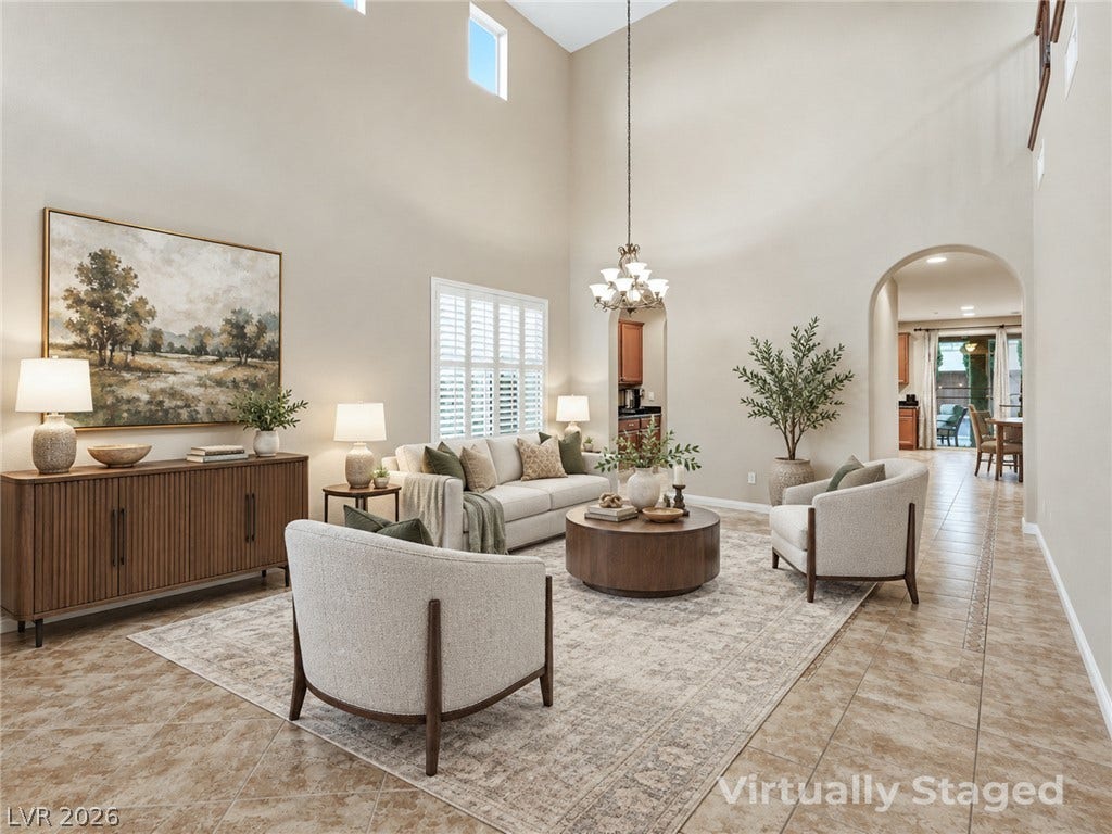 Soaring vaulted ceilings and classic arched doorways define this spacious tiled gathering area.