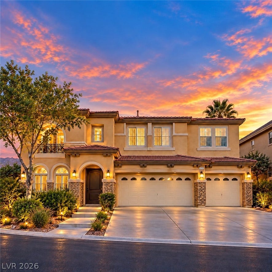 Stately architectural details and a spacious driveway define this impressive exterior.