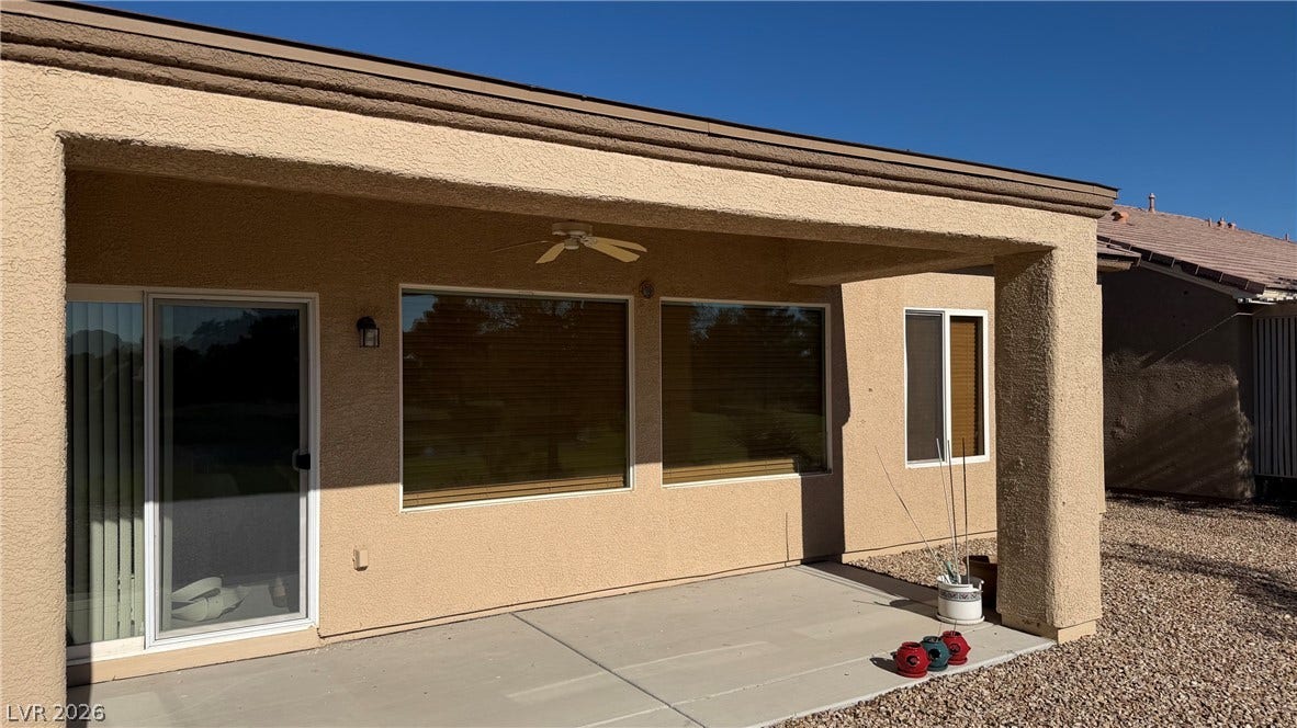 Covered patio with a ceiling fan/lights.