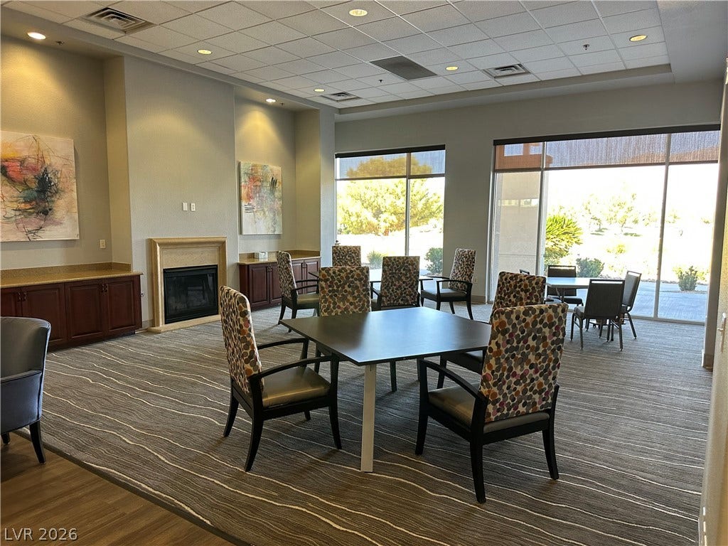 A spacious social lounge with a fireplace.