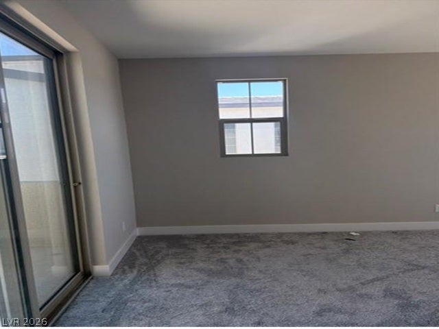 Plush carpeting and natural light define this versatile room with sliding glass door access.