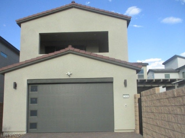 Clean lines and a modern garage design define this contemporary multi-level home exterior.