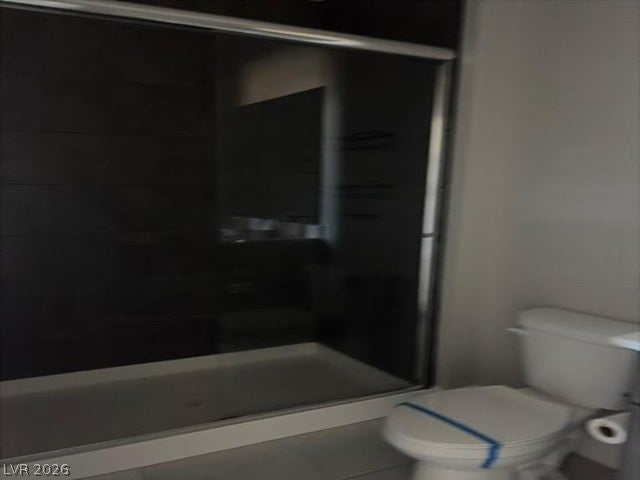 A glass-enclosed walk-in shower highlights this modern bathroom space.