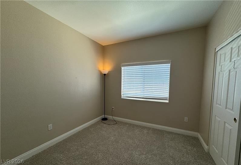 High ceilings and soft carpeting define this quiet secondary bedroom.