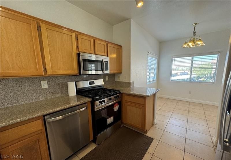 Warm wood cabinetry and granite countertops frame this functional space with an adjacent dining area.