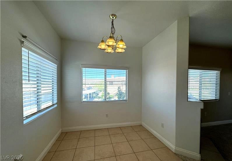 Tiled flooring and large windows bring classic character to this bright breakfast nook.