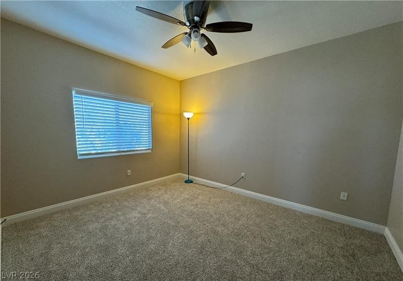 Plush carpeting and baseboard trim highlight this comfortable bedroom space.