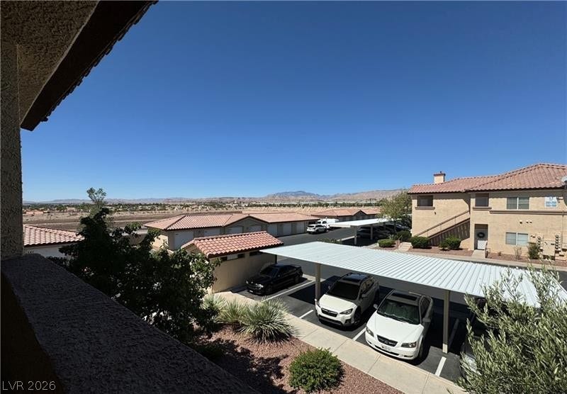 Distant mountains frame the horizon beyond the covered parking areas of this residential community.