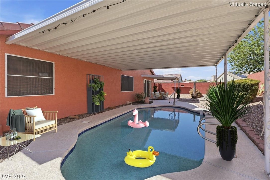 Virtually staged An inviting backyard pool sits beneath a spacious covered patio structure.