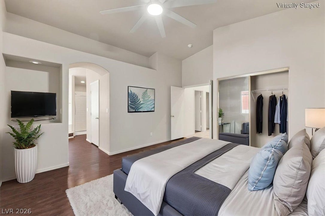 Virtually staged primary suite. Gleaming hardwood floors and a recessed media niche elevate this spacious primary suite.