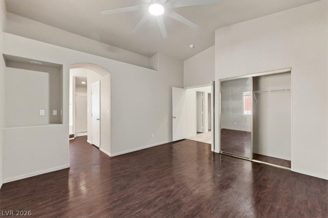 Gleaming hardwood floors and vaulted ceilings elevate this airy bedroom suite. Wardrobe closet doors.