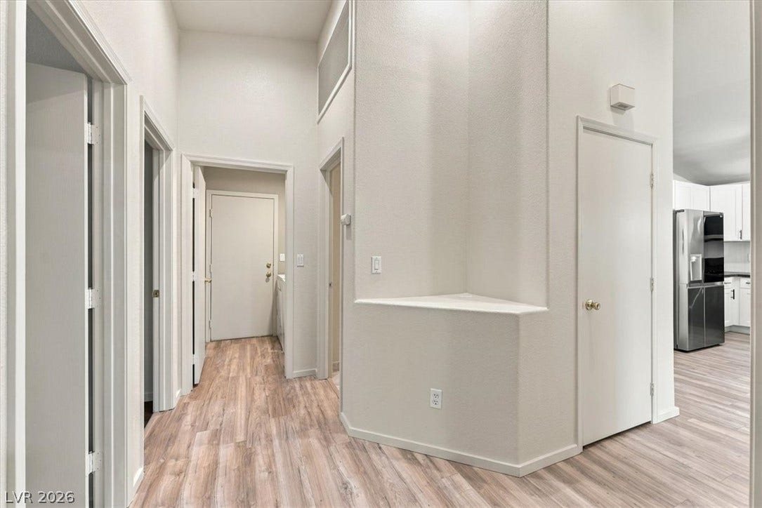 High ceilings and clean architectural lines define this welcoming central entry hall.