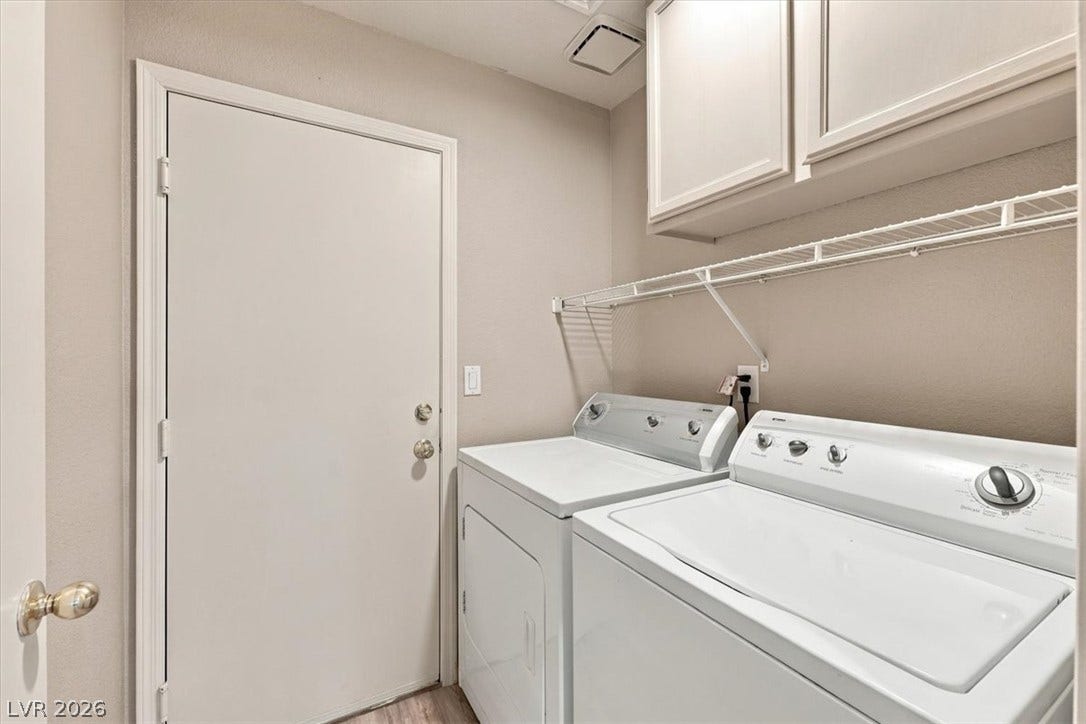 A functional laundry area includes built-in cabinetry above the appliances and a direct entry door. Washer/ Dryer convey.