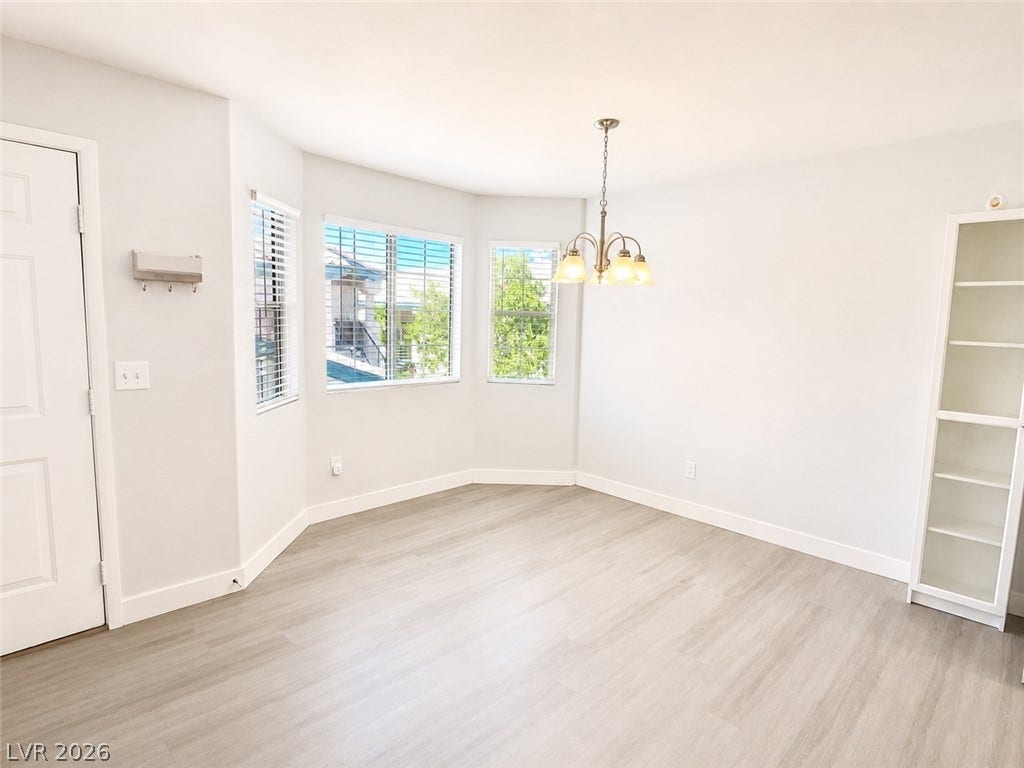 Clean lines and smooth vinyl flooring define this versatile dining area with bay windows.
