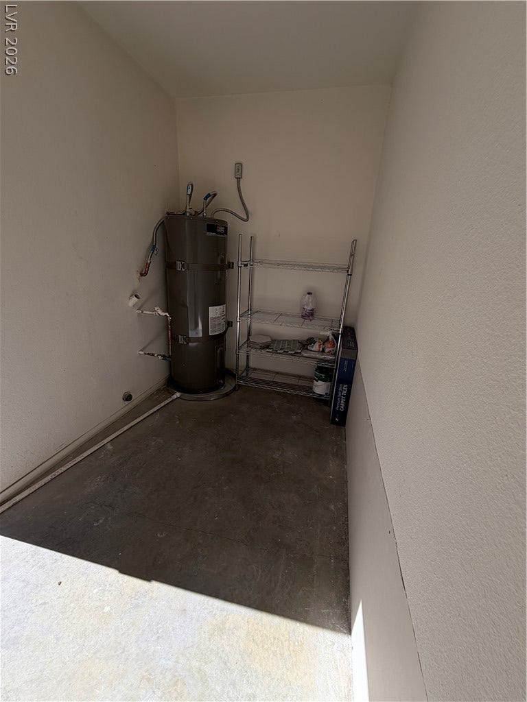 A dedicated utility space features concrete flooring and clean neutral walls.