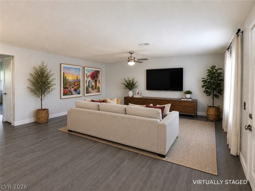 Smooth walls and dark plank flooring define this inviting main living area.
