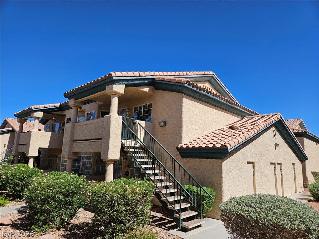 Spanish tile roofing and classic stucco finishes highlight this multi-level residential design.