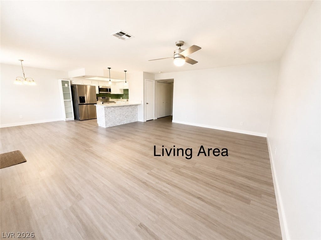 Smooth wood floors flow effortlessly through this versatile, open-concept living space.