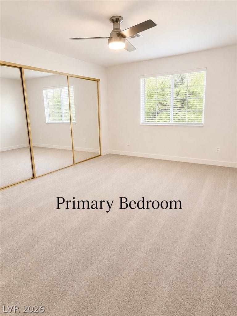 Plush carpeting and mirrored closet doors define this comfortable bedroom space.