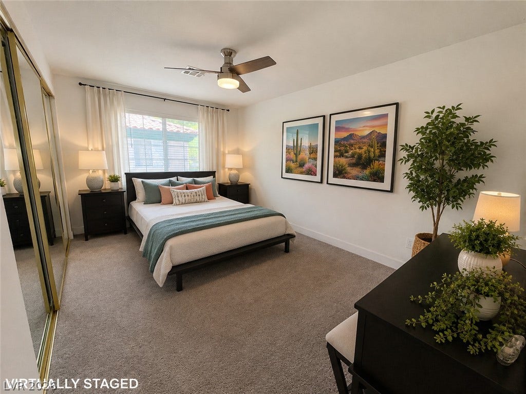 Plush carpeting and mirrored sliding closet doors define this comfortable bedroom space.