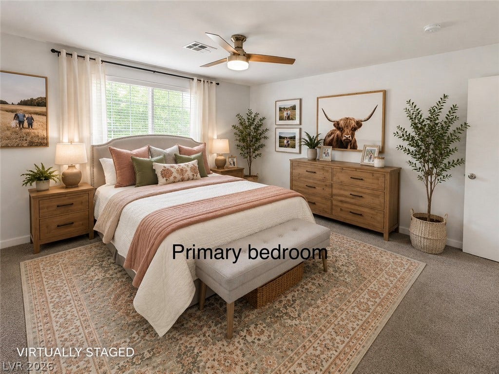 Natural light streams through a large window, illuminating soft carpeted flooring in this comfortable bedroom.