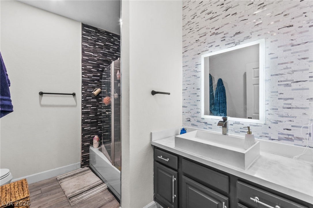 5250 S Rainbow Boulevard, #2033, Las Vegas, NV 89118 Modern tile accents and a sleek vessel sink elevate this contemporary bath space.
