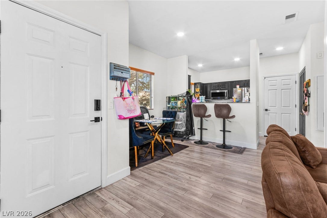 5250 S Rainbow Boulevard, #2033, Las Vegas, NV 89118 Gleaming wood-look floors anchor this open-concept layout leading directly into the kitchen.