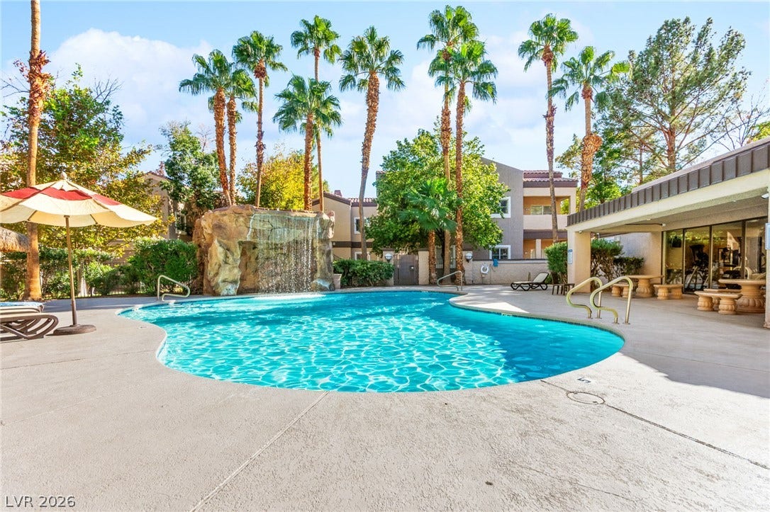 5250 S Rainbow Boulevard, #2033, Las Vegas, NV 89118 Towering palm trees and a rock waterfall feature frame the refreshing community pool.