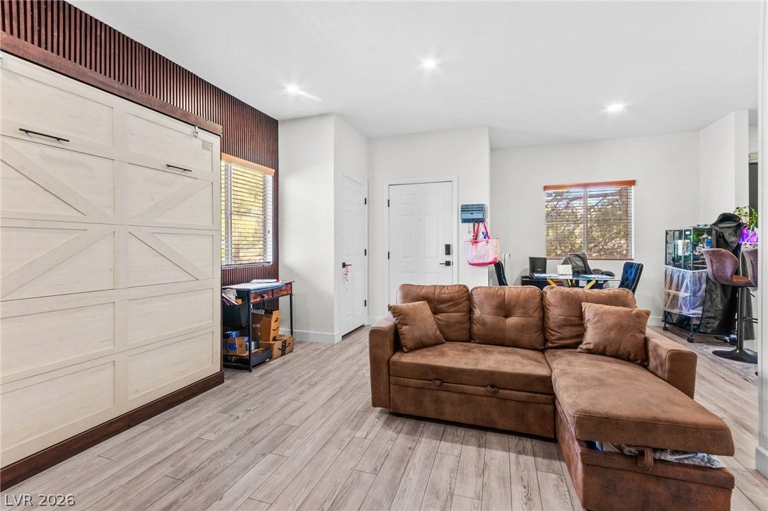 5250 S Rainbow Boulevard, #2033, Las Vegas, NV 89118 Smooth wood-look flooring and integrated recessed lighting enhance this versatile living space.