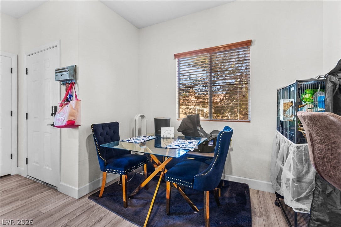 5250 S Rainbow Boulevard, #2033, Las Vegas, NV 89118 Crisp white walls and clean wood-look flooring establish a bright dining area setting.