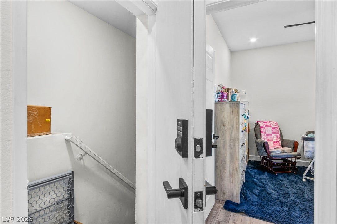 5250 S Rainbow Boulevard, #2033, Las Vegas, NV 89118 Smooth wood flooring and clean white walls define this transition space leading upstairs.