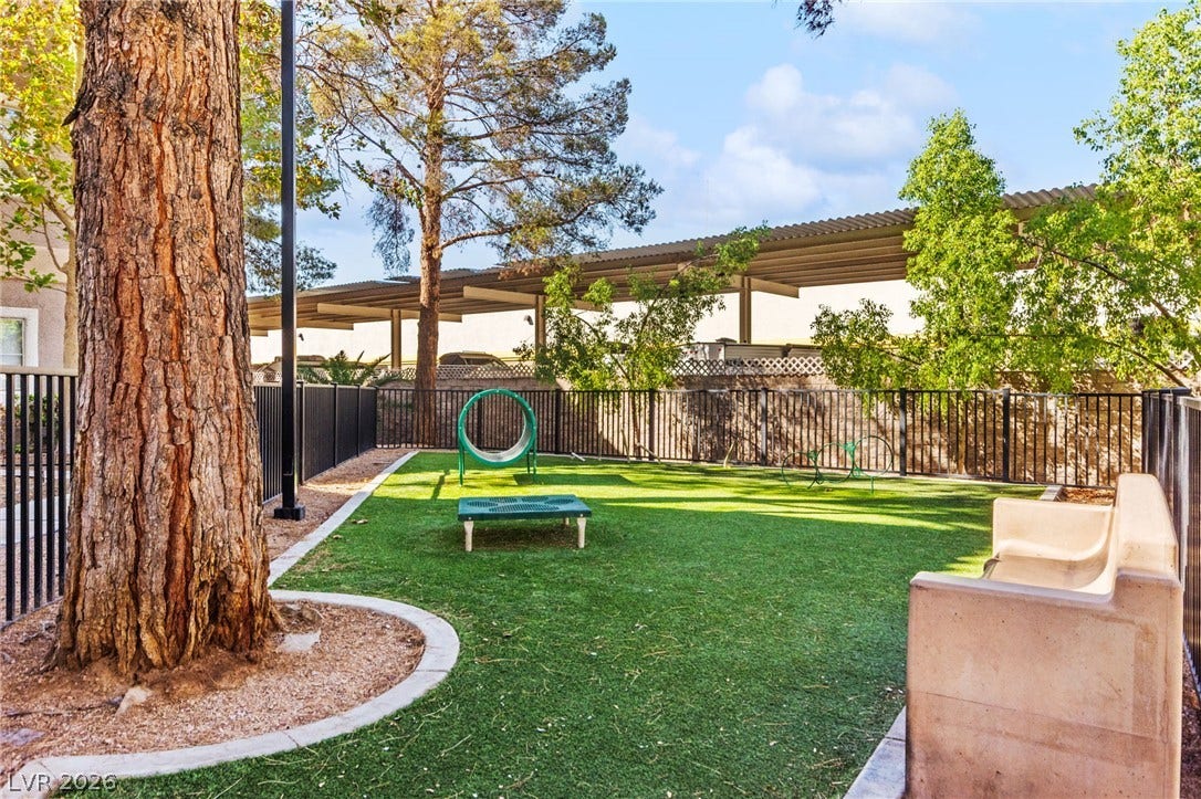 5250 S Rainbow Boulevard, #2033, Las Vegas, NV 89118 Mature trees shade a secure, fenced community dog park with synthetic turf.