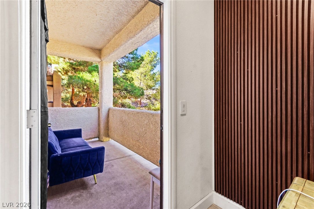 5250 S Rainbow Boulevard, #2033, Las Vegas, NV 89118 A covered private balcony looks out over mature trees.