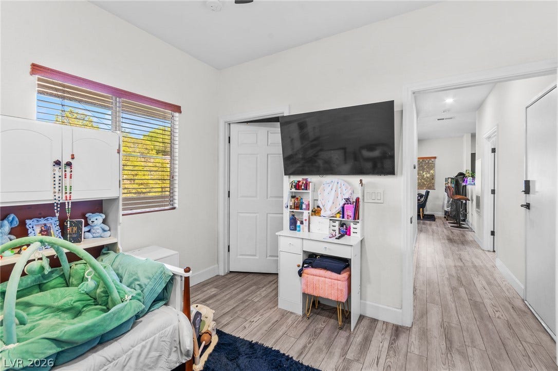 5250 S Rainbow Boulevard, #2033, Las Vegas, NV 89118 Streamlined wood flooring runs throughout this serene bedroom space.