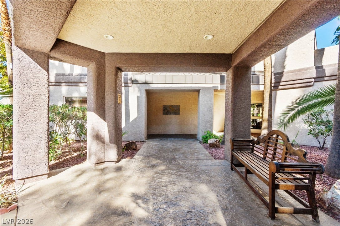 5250 S Rainbow Boulevard, #2033, Las Vegas, NV 89118 A covered stone entryway features recessed lighting and leads into the main structure.